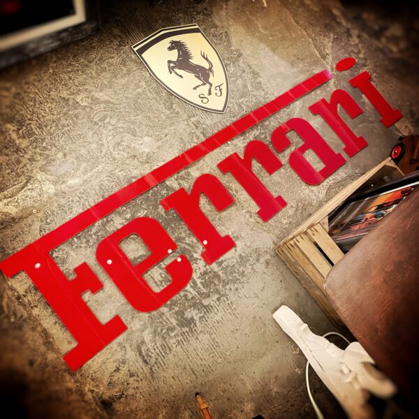 Ferrari wall sign with metal emblem badge and red lettering, handmade in the UK by WHIPD Automobilia – ideal for garages, man caves, and car displays.