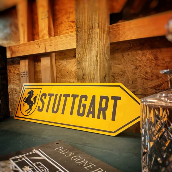 Stuttgart yellow arrow sign displayed in performance car garage